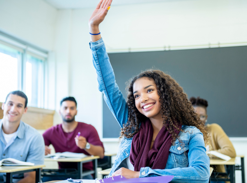 Girl raises hand in class